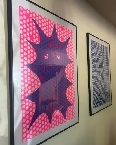 Pink and navy pop art print on a gallery wall