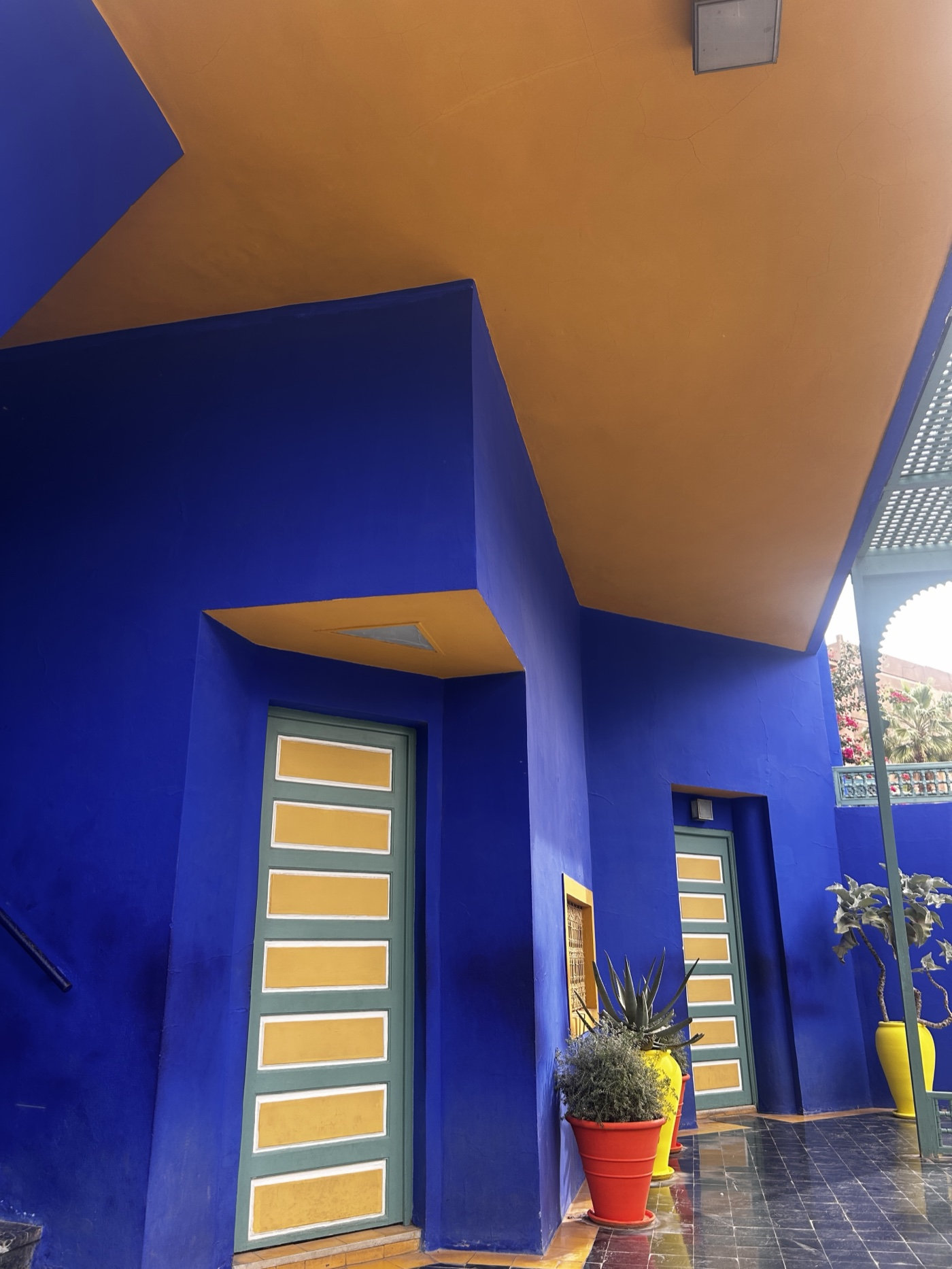 Cobalt blue walls and yellow door panels at Jardin Majorelle in Marrakech.